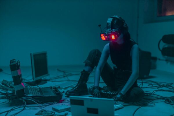 a person sitting on the floor with vr goggles using a computer