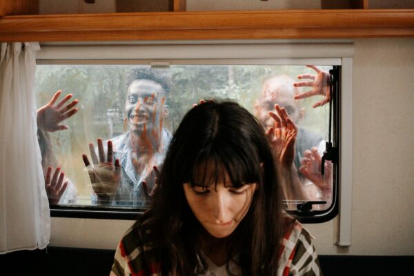 zombies on window behind a girl